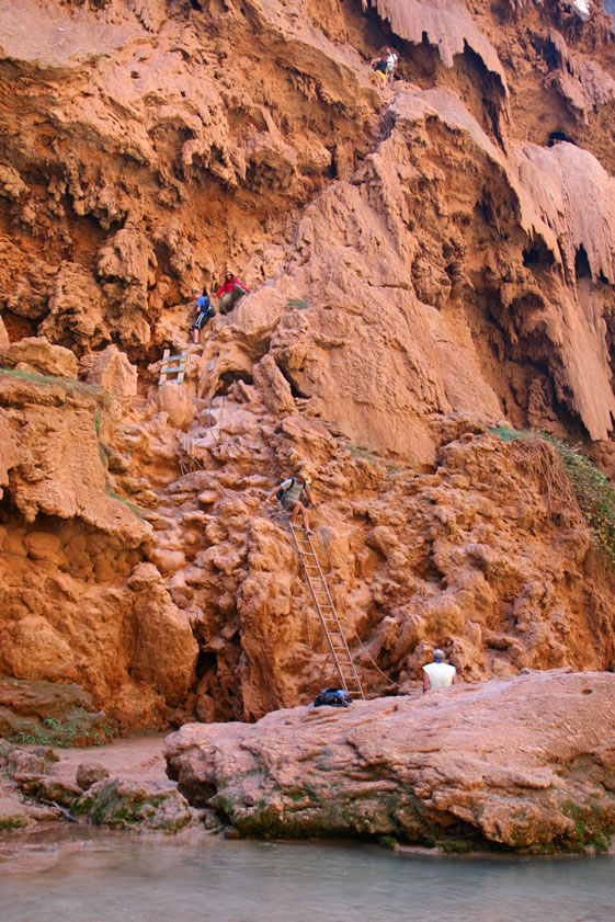 The tenacious trio arrive back at the Mooney Falls climb and kick back while several groups climb up and down the cliff face.