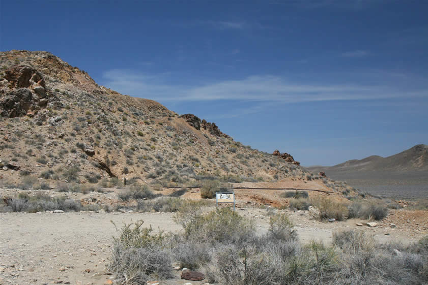 At the eastern edge of Providence Ridge, just another short walk away, is Pete's Eureka Mine.  Just behind the interpretive sign in the middle of the photo you can see the rails leaving the mine and heading past the site of the blacksmith shop as they end at the dumps.