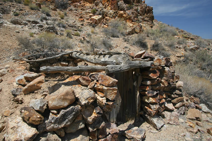 In this closer view you can see the wooden door and the massive ridge pole.