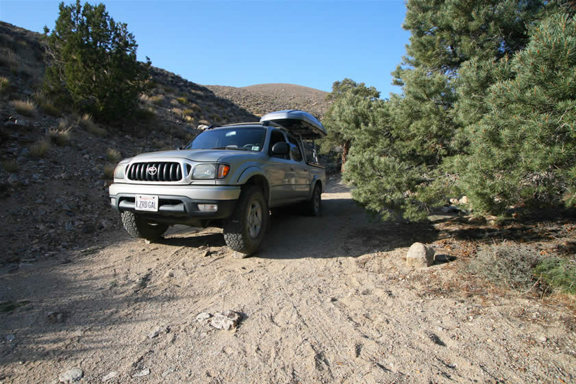 It's a tight fit getting into this spot and turning around.  Then we have to dig holes for the rear tires and prop the front ones up on rocks to level the truck so we don't slide to the downhill side of the truck bed during the night.  It's worth it, though.  This is a beautiful and snug campsite.