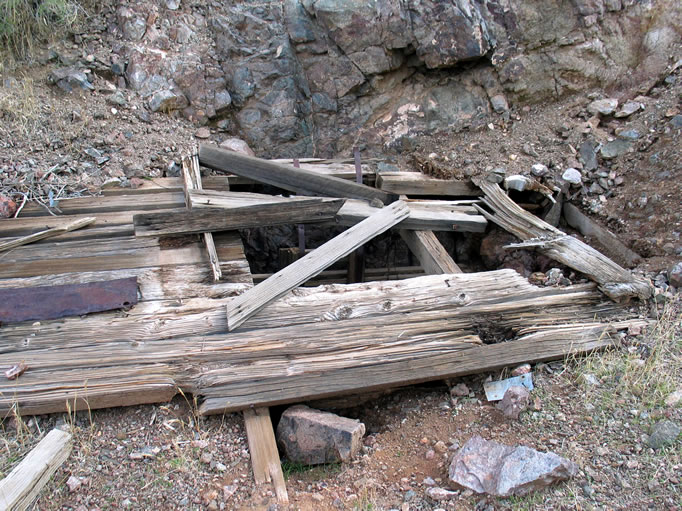 The rotted boards and crumbling earth collar around the shaft didn't look very safe.