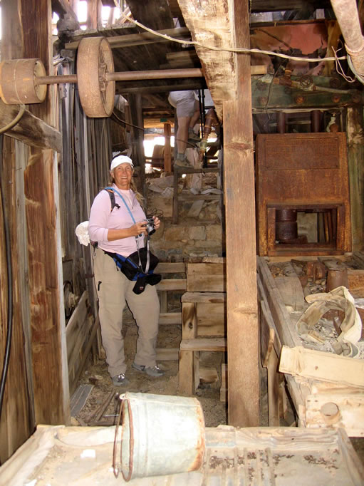 To the right you can see the two stamp battery with one stamp down.  In front of that is the amalgamation table where gold would be extracted from the crushed ore as it passed over copper plates coated with mercury.  In the foreground, with the bucket on it, is a Meyer concentration table.  This is an additional process where gold would be trapped in the wooden riffles of the slanted table as it shook back and forth.