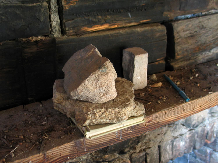 We find the log book on the mantle.  We're guessing that the rocks on top of it are to keep the rats from carrying it off!