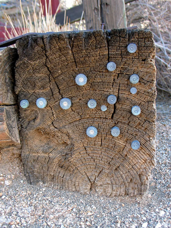 As you might expect, pistol and rifle cartridges abound.  Some creative soul even hammered a few into the end of one of the railroad ties that were used to build the cabin.