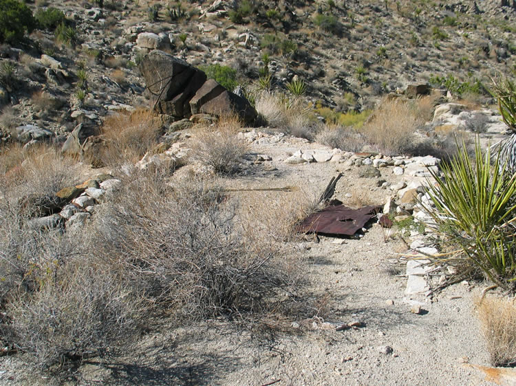 This route takes us down the face of the slope below the cabin and it's here that we find the foundation of another structure.