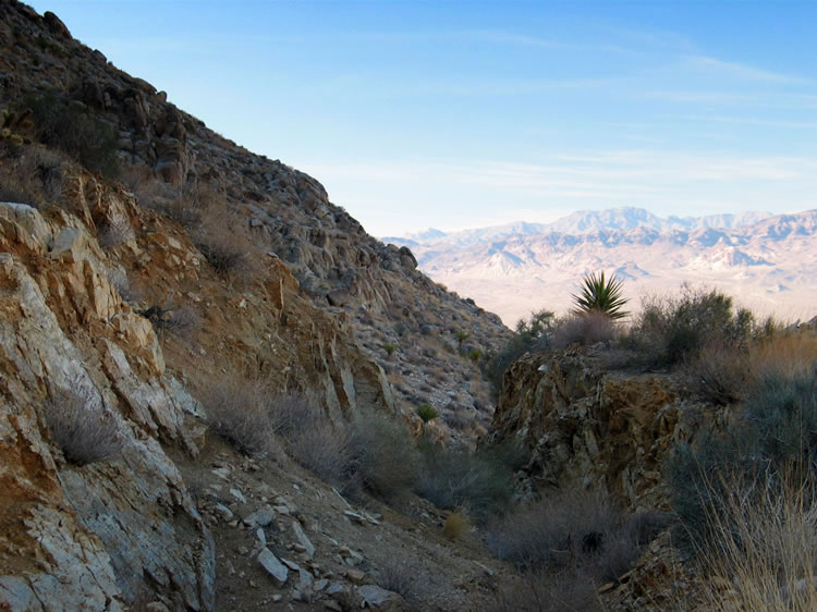 While she's up there she also explores a long open cut that extends up the canyon toward the west tunnel.