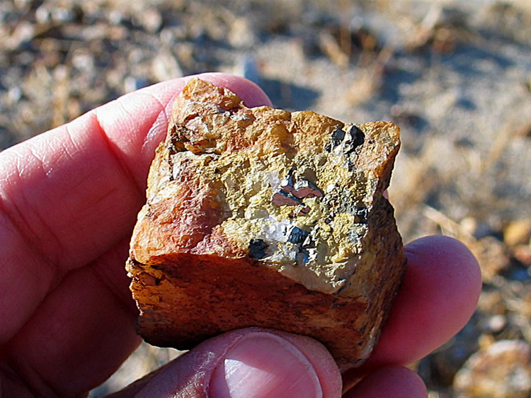 We also find a small pile of ore.  Here's a close-up showing a piece containing some sort of metallic crystals.