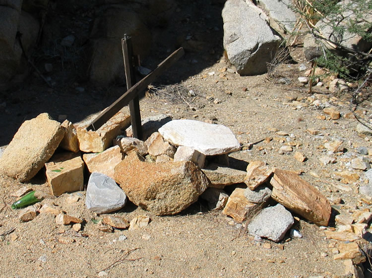 Up against the base of the knoll are some stacked stones capped with a makeshift cross.