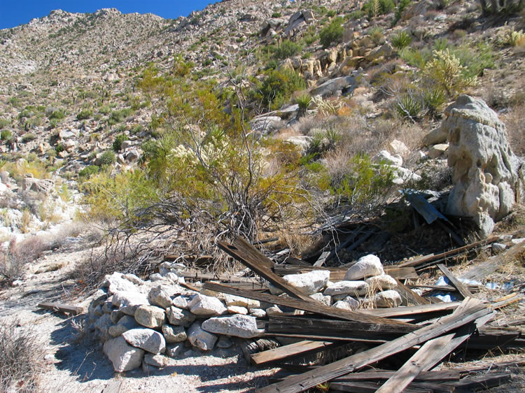 Up near the water tank is a small stone foundation and some boards that appear to be from an old outhouse.