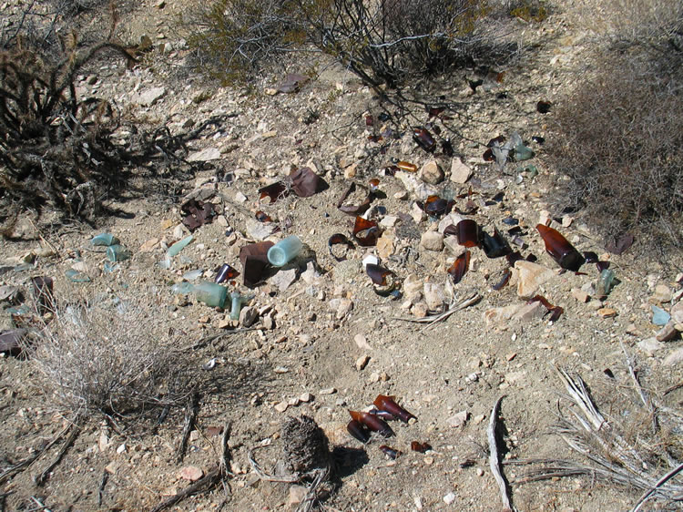 On the hillside above the camp are some trash scatters with old bottles and cans.