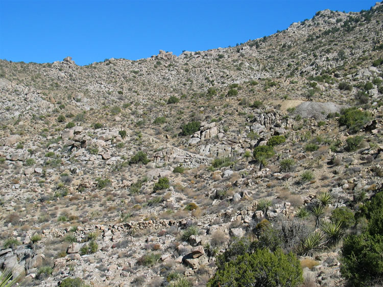 It looks like our trail will come to the tailings piles from the right.  After checking out that area we'll take the old 