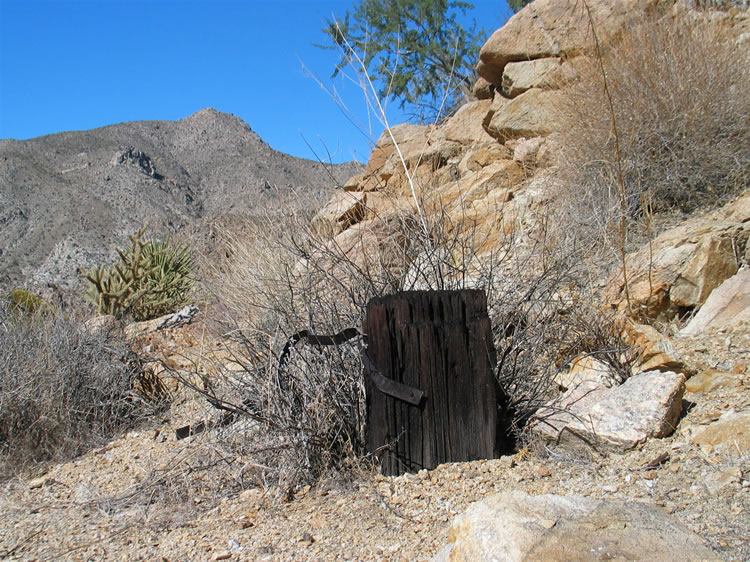 It appears that a small shack once occupied a flat spot by the shaft.  We find an anvil stump there hinting that the shack might have housed the blacksmith.