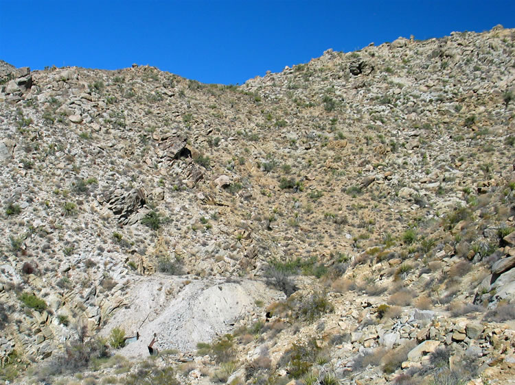 We approach a large tailings pile at the head of the wash.