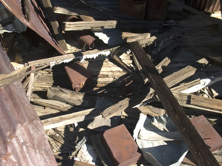 Lots of other debris is strewn around the cabin ruins.