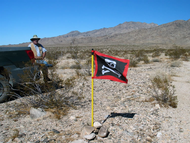 We finally straggle back to camp and are cheered to see the Jolly Roger flying and find Mohave, the camp sheriff, keeping an eye on things.  In fact, while we were gone this morning he checked out a site that we planned to visit in the afternoon.  He hinted that it might make up for our fruitless cabin search this morning.