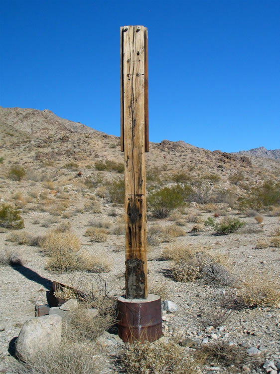 Adjacent to the cabin ruins is what looks like a makeshift electric pole.  There are two old style insulators at the top, which makes it likely that they generated their own electricity here.