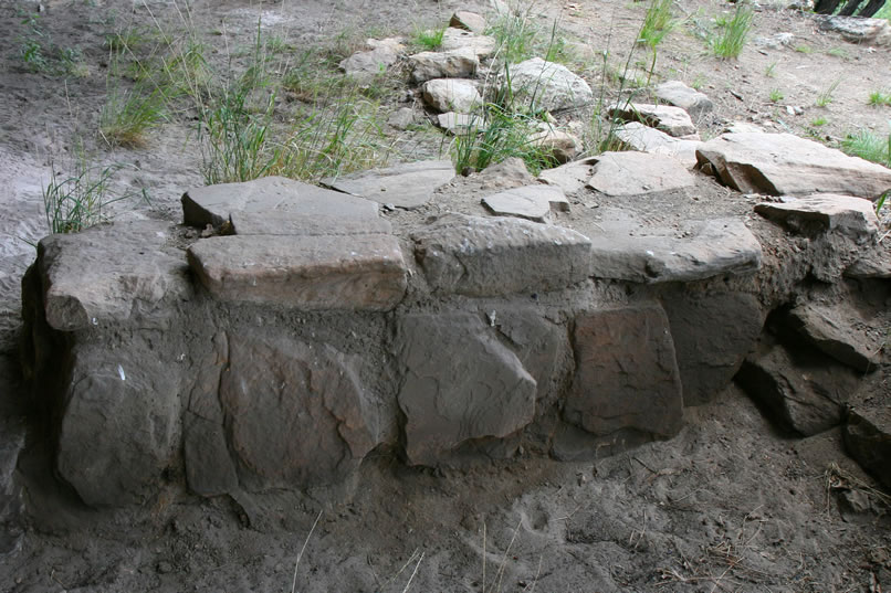 A closer look at the remains of part of the rock wall foundation.