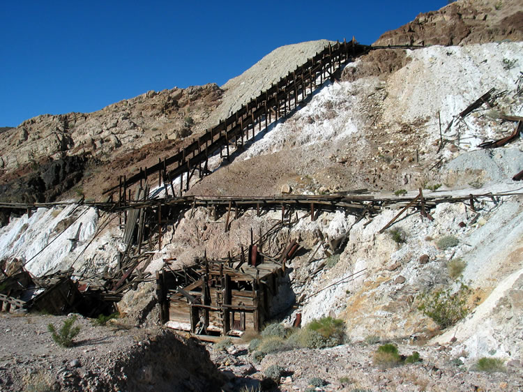 As we hike up the heavily eroded road, each step unfolds a different view of the twin chutes and the ore hoppers below.
