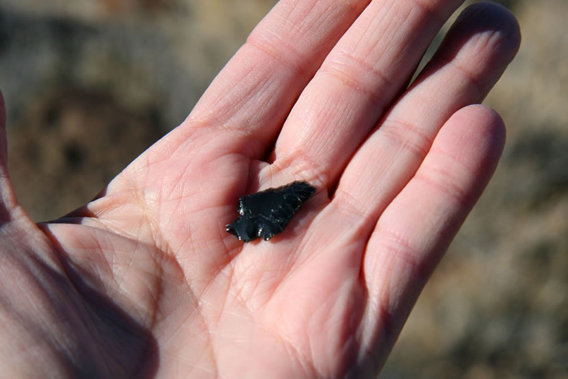 When you consider that we're just hiking cross country, the odds of finding an arrowhead out here must be pretty astronomical.  Jamie's find is a small obsidian point that's intact except for the very tip.  After replacing it, we hurry on our way with renewed excitement.