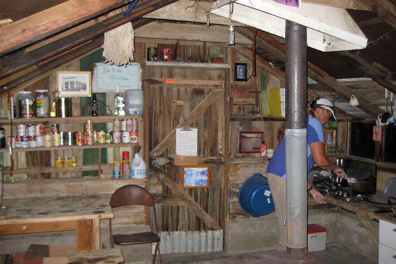 We're pleasantly surprised when we open the door.  Not a rat poop is in sight and everything is neat and tidy.  Not only that, but there's a stove!  While Niki gets the stove going, Jamie tackles dinner on our two burner propane cook stove.