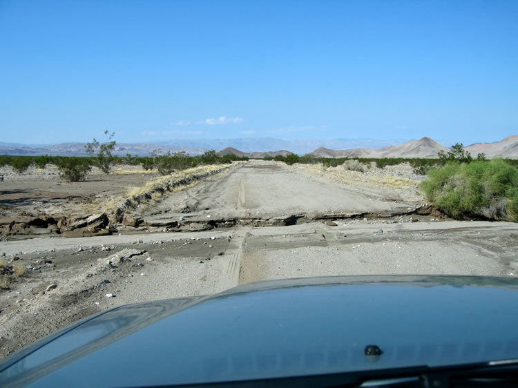 This normally well graded road showed the effects of recent storms that had pounded the desert with rain.