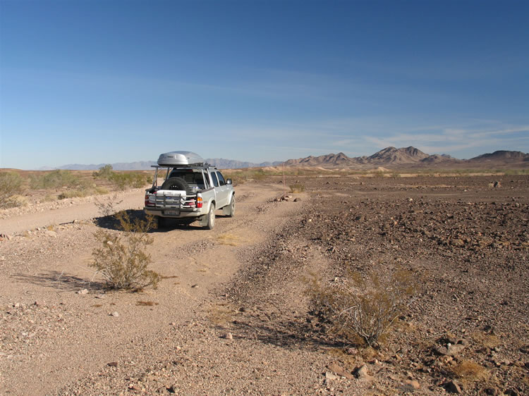 We'll be leaving the Lizardmobile here alongside Milpitas Wash Road today because the wilderness boundary is right next to the road.  In fact, you can see one of the wilderness boundary markers just ahead of the truck and to the right.