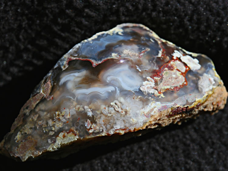 After returning home from the trip, we polished up a few of the pieces that we collected.  This agate gets a colorful boost from the inclusion of a bit of red hematite.
