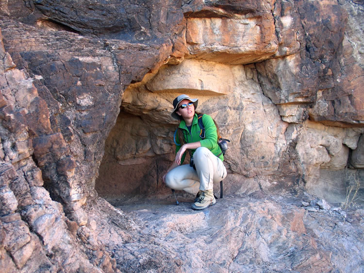 Niki at the entrance to one of the shallow rock shelters.