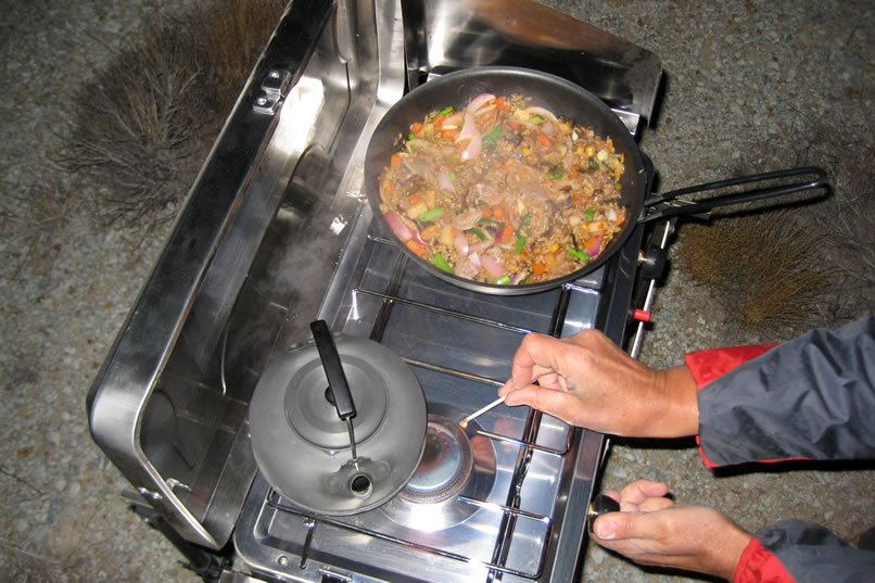 While the carnitas stir fry simmers, she gets the kettle going for some mugs of hot green tea.