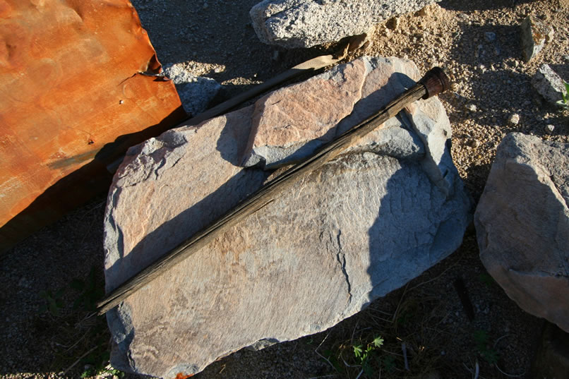 This appears to be the handle of an old broom.  It must have been difficult to keep anything clean out here!