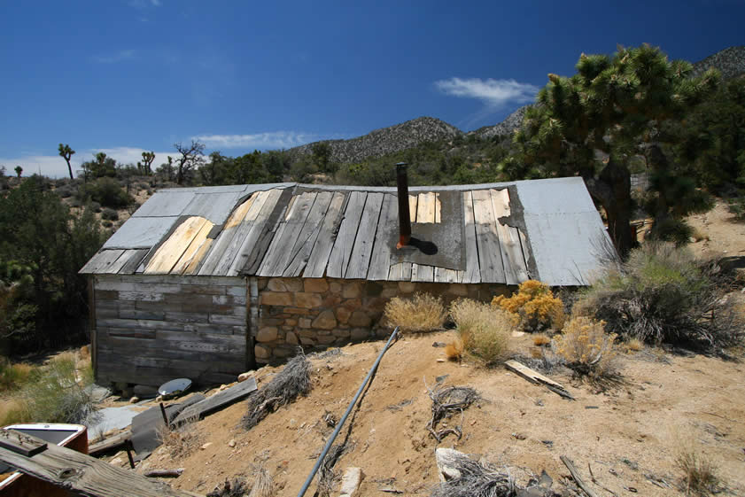 In the 1920's Depression era, several miners worked the placer claims near here and constructed this rock and wood structure.  It's located a short distance from a 1970's era structure built by another crusty old miner named McClure.