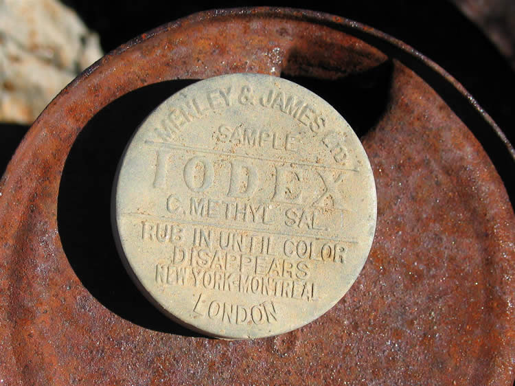 A small aluminum sample tin of Iodex, an iodine ointment.  It's in great shape and we tuck it away in the bottom of the pile to protect it from the elements.