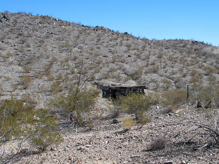 As we draw closer, though, we encounter a dilapidated structure built into the side of the wash.