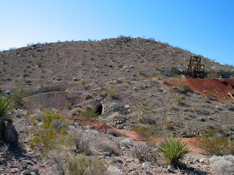 As we climb back up toward the tailings pile we take this photo looking back at the mine.  You can see the tunnel we exited from in the center of the photo and the headframe up to the right.