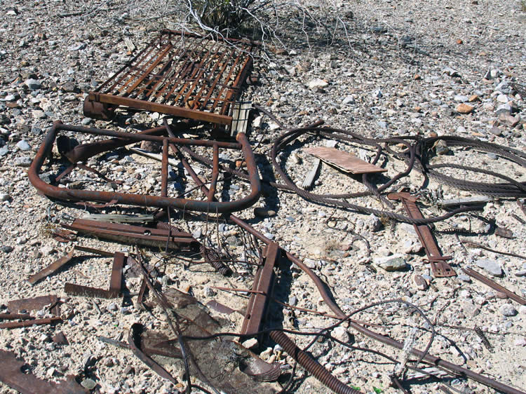 Nearby is an old bed frame and mattress and other odds and ends including some heavy duty wire cable.