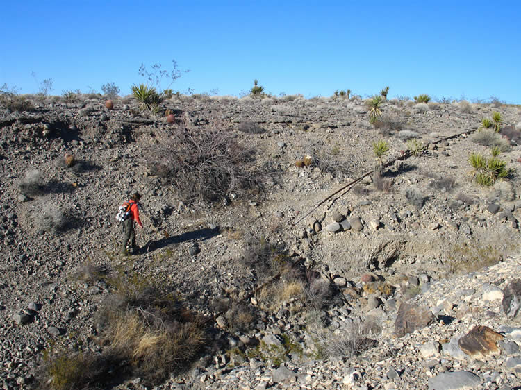 The pipes continue up the other side of the wash and on across the desert.  We're hooked and keep hiking.