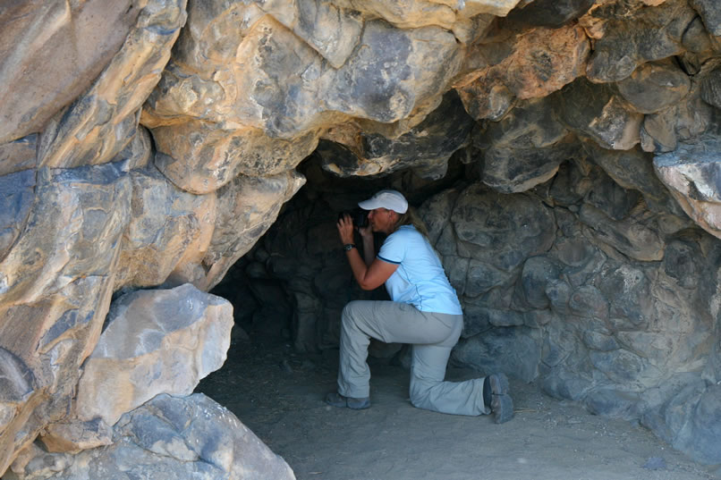 After a few shots from the entrance, we move to the back of the cave to get a better view of the petroglyph boulder.