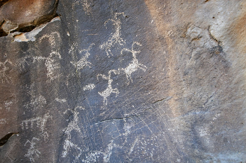 The scratching that you see in this even closer view is what's referred to as Numic scratching.  The Numic people were more recent Indian tribes who, as they moved into areas abandoned by earlier tribes, typically scratched over the petroglyphs of the original creators.  Although we'll most likely never know the real reason for this, many postulate that this was done to negate the potency of these pre-existing images.