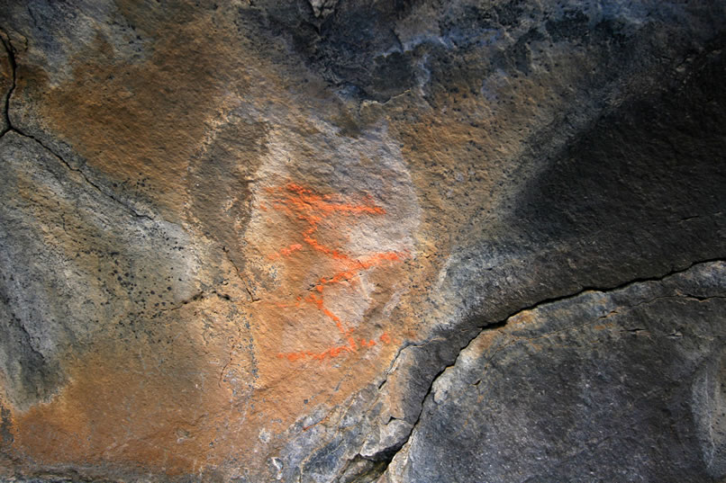 As we continue to move southwards along the basalt cliffs, we're pleased to find a string of small pictographs.  Like this one, they're all done in orange pigment.