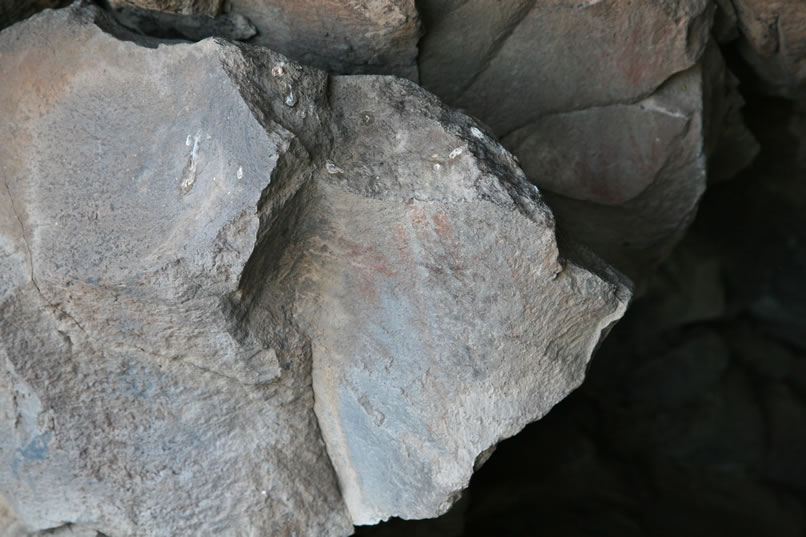 The reason we wanted to return to the Stahl Site Cave was because in the bustle of activity this morning, we forgot to look for the faint pictographs that are mentioned in the archaeological records pertaining to the cave.  It takes a little while, but finally we can make out two separate boulders with faint red pictographs.  Here's a look at the first boulder.  The second, which we'll focus on in the next photo, is just behind this first one.  