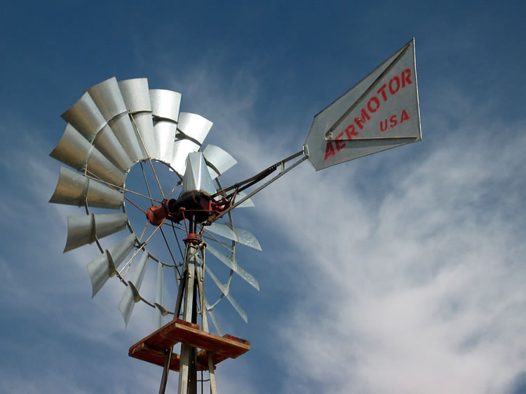 The Aermotor Windmill Company, which began in 1888, is still in business today in San Angelo, Texas.  This windmill is busy pumping water into a low tank for the local cattle.