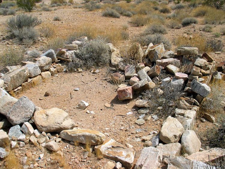 A small stone foundation near the can dump.