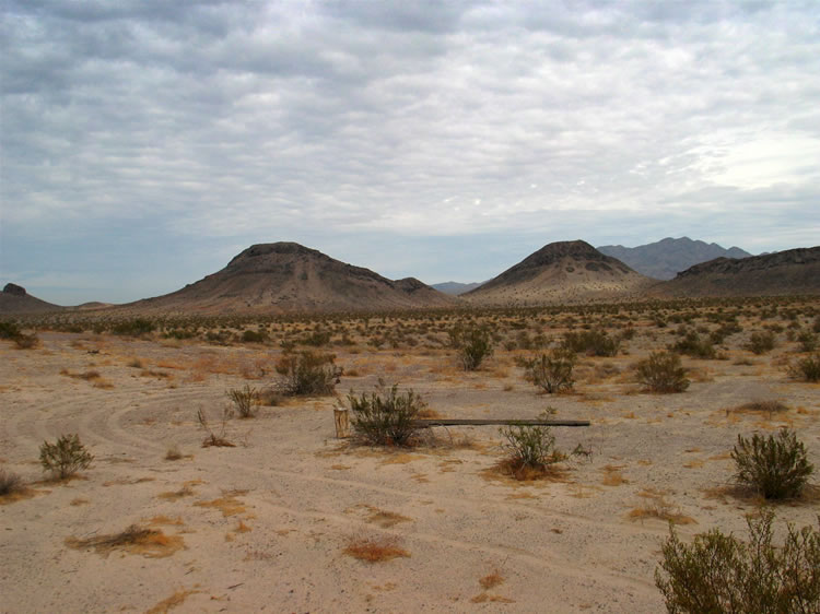 A look back at the brown buttes and their Tertiary volcanic flows as we continue toward the old iron mine.