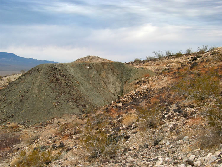 We head for the largest tailings pile.