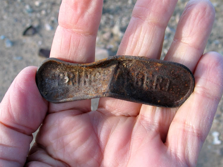 What appears to be a push type lid to a Prince Albert tobacco container.