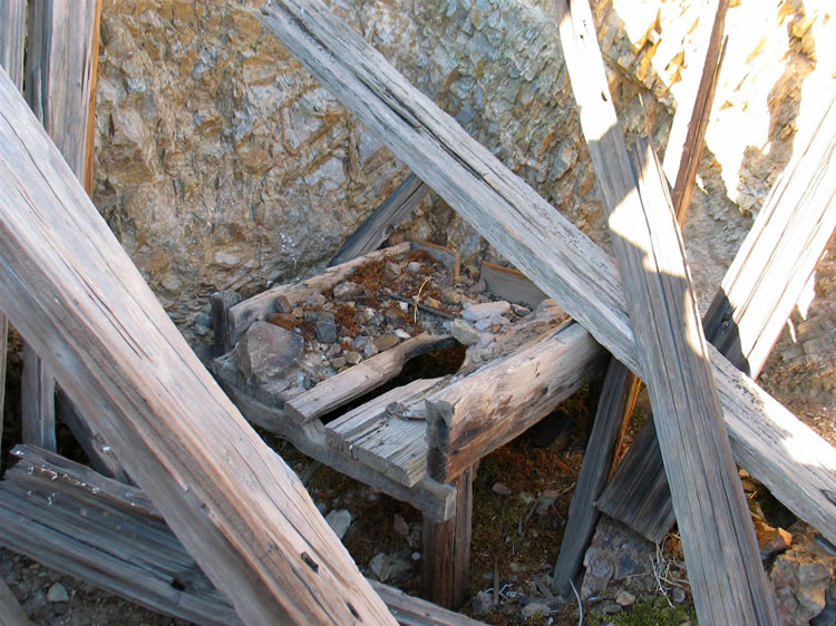 The structure turns out to be the wooden base for a pan forge that a blacksmith would use to heat drill bits before sharpening or for any number of metal repairs or fabrication.