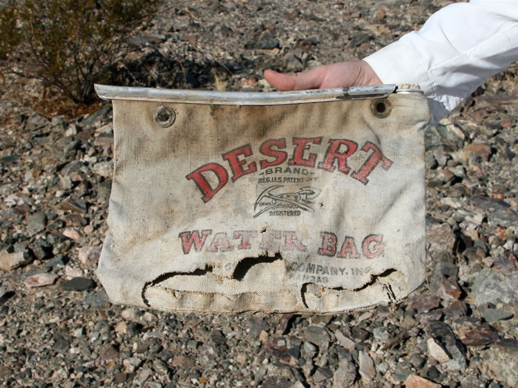 However, we spy a foundation not too far from the road and make a detour to it.  Along the way we find this old canvas water bag.