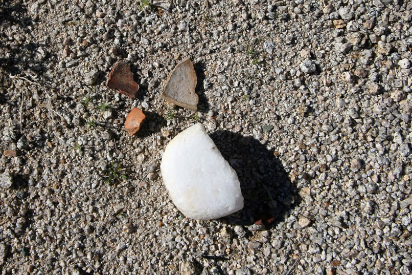 There are several pottery fragments but the most impressive find is the broken bottom potion of an opaque quartz pestle or mano.