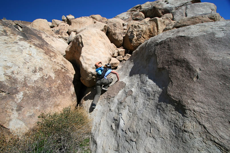 Niki doing her best lizard imitation as she scrambles up the face of this boulder to check out a possible shelter up above.