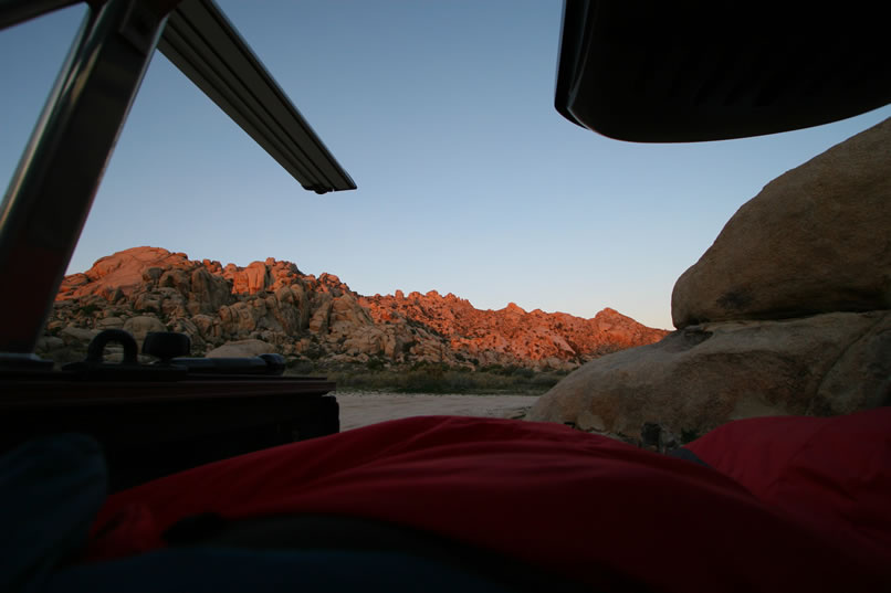 The sunrise paints the hills behind our campsite.